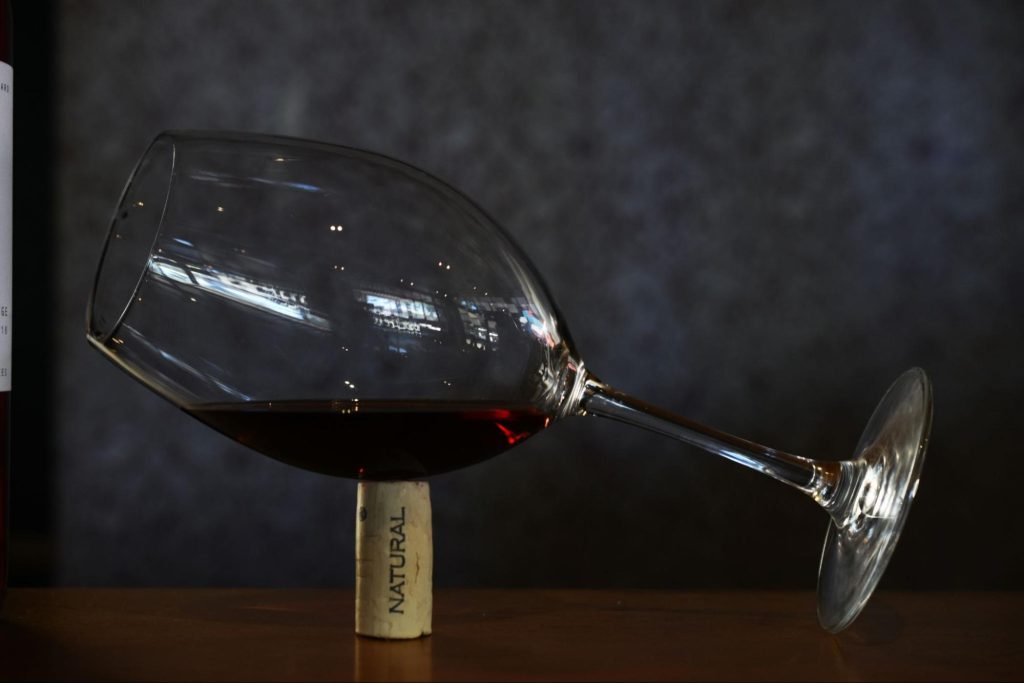 Glass of red wine with vineyard in the background