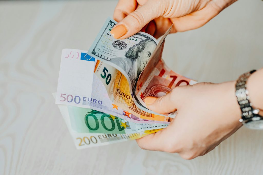 Hands holding euro banknotes for payment