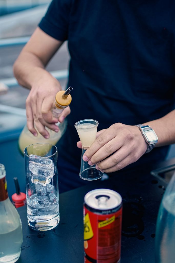 Bartender preparing a drink at bar counter