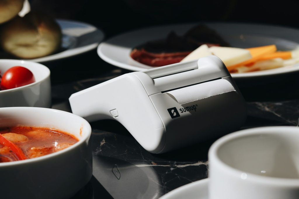 Card payment terminal and receipt on restaurant table