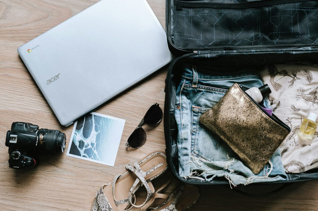 Suitcase with travel items and clothes packed