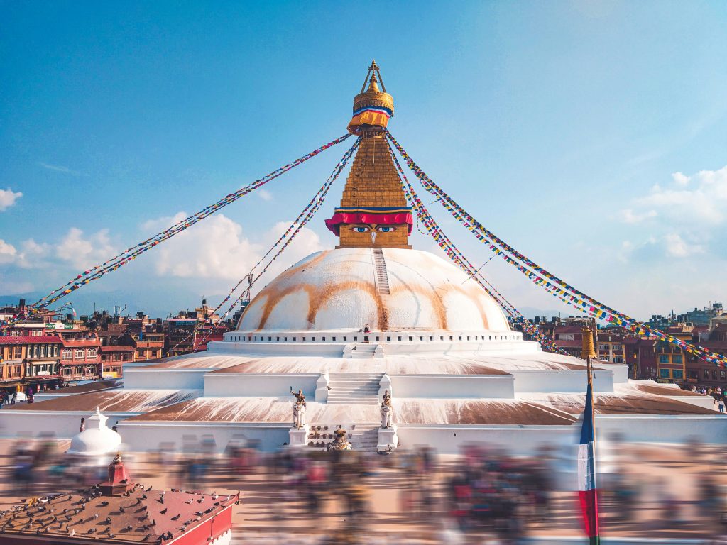 Boudhanath Stupa in Kathmandu, Nepal, with Buddha eyes and colorful prayer flags.